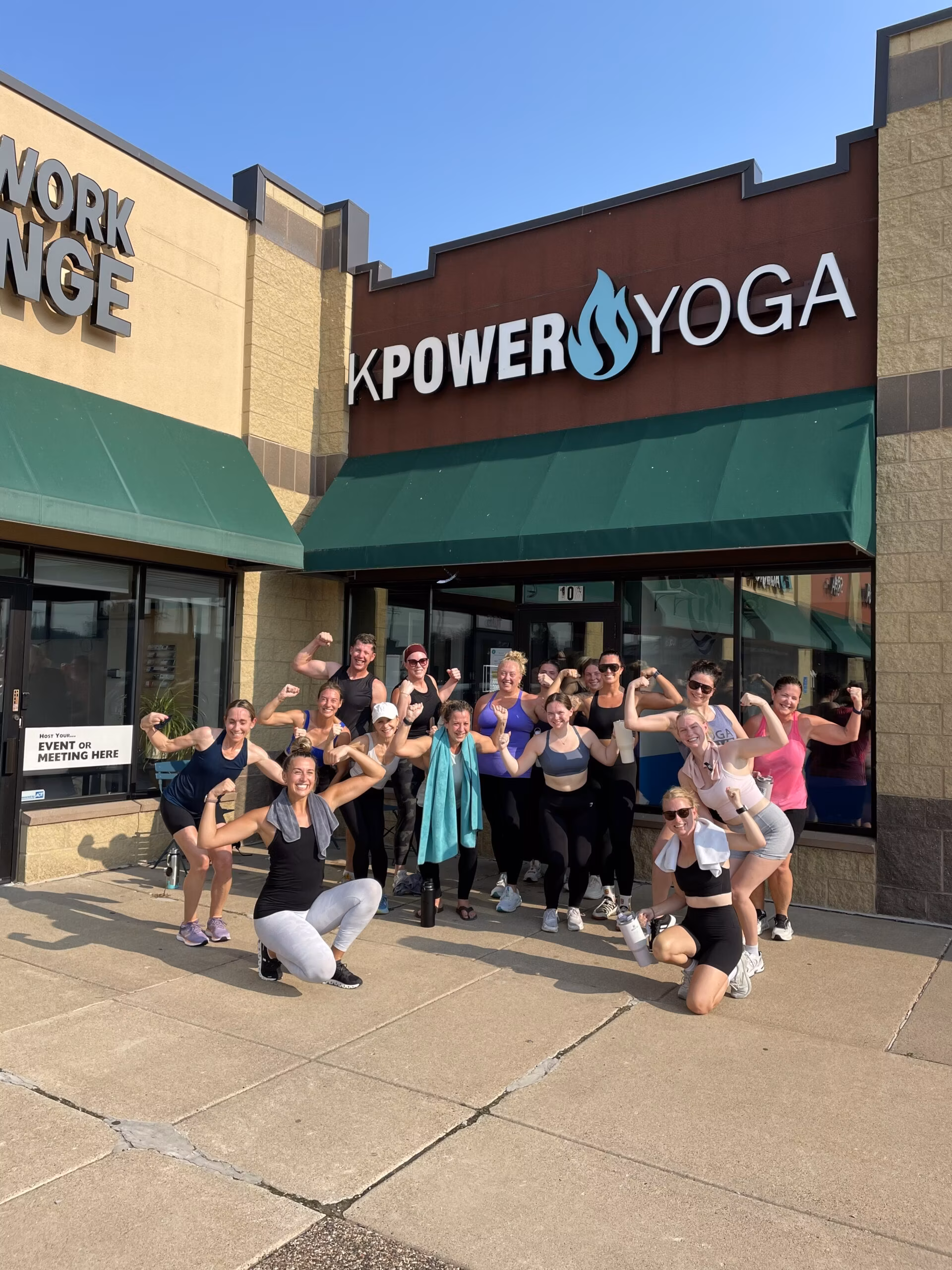Members celebrating outside the Sartell studio on a summer morning